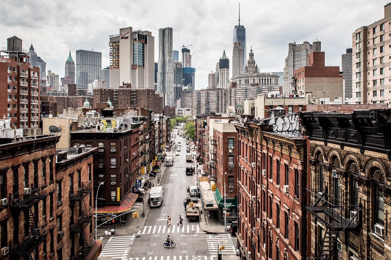A bustling city street in New York with tall buildings and traffic.
