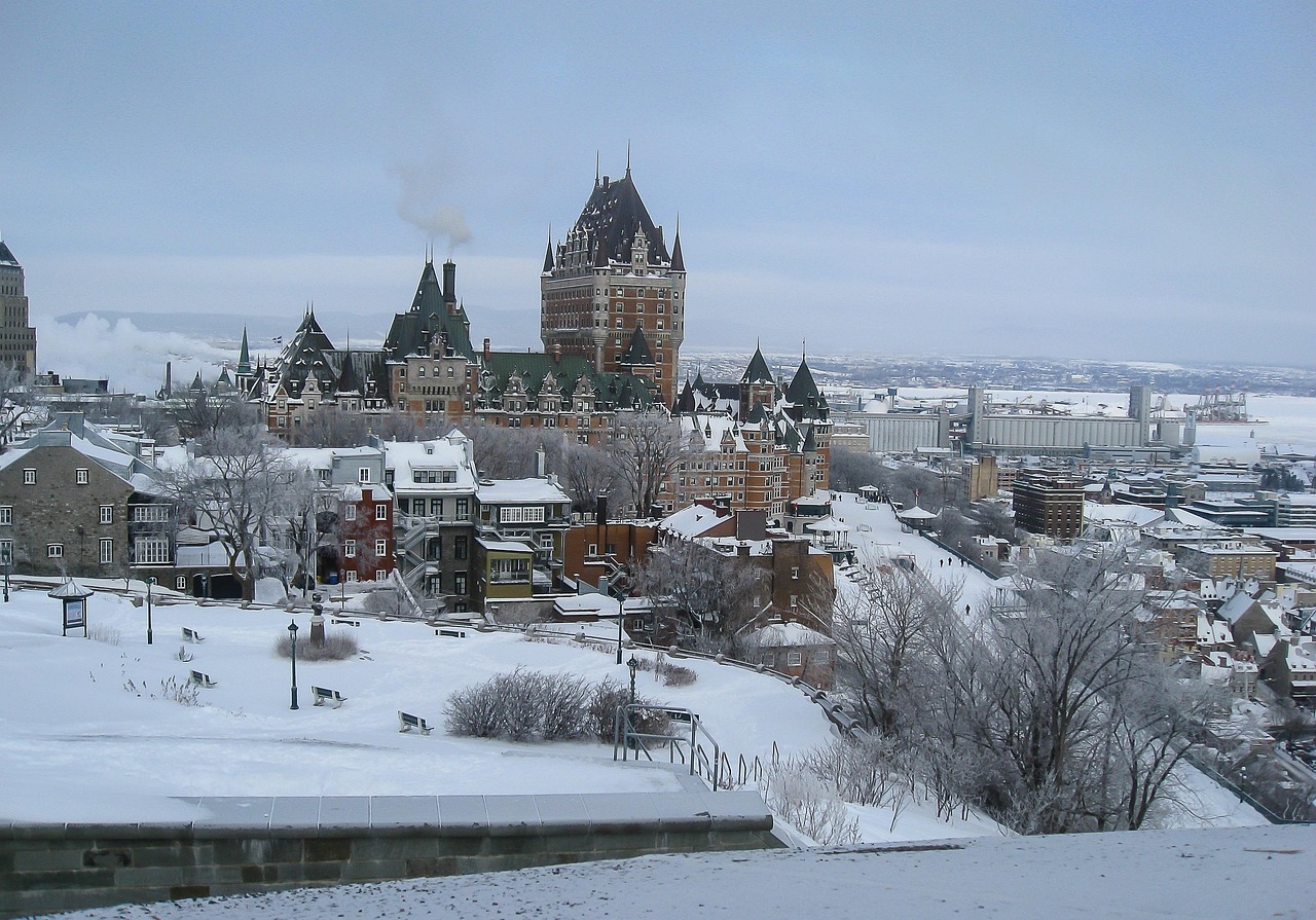 A snowy cityscape featuring the Château Frontenac and other historic buildings in Quebec City, Canada.
