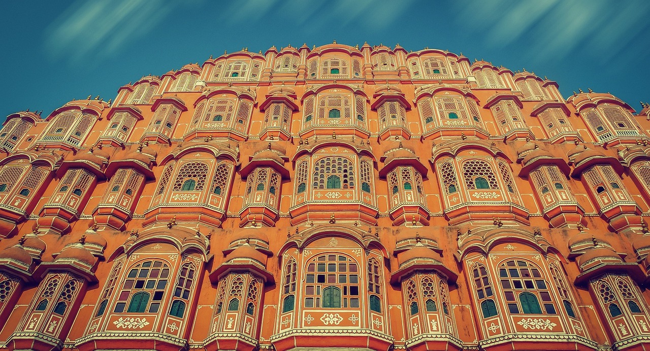 The ornate pink and red facade of the Hawa Mahal palace in Jaipur, India.