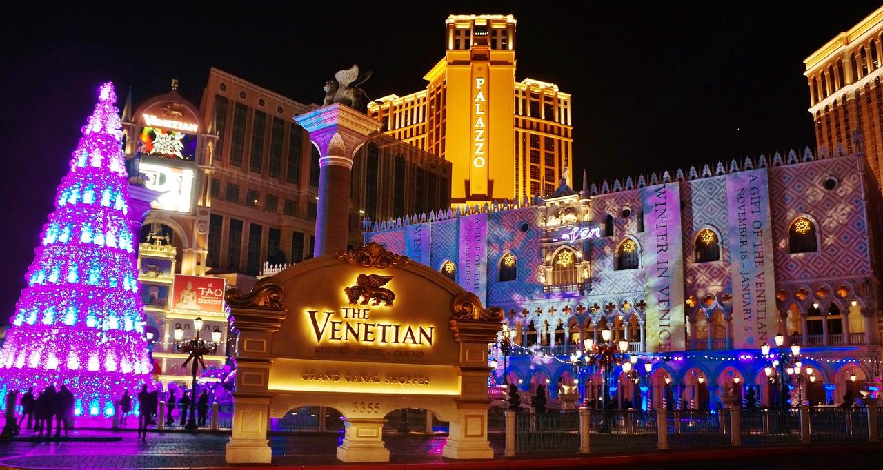 The Venetian hotel and casino in Las Vegas at night with a large Christmas tree and holiday decorations.