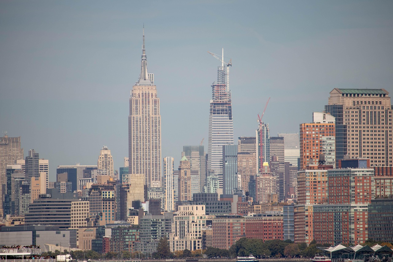 A cityscape featuring tall buildings and skyscrapers, including the Empire State Building and other recognizable landmarks in New York City.