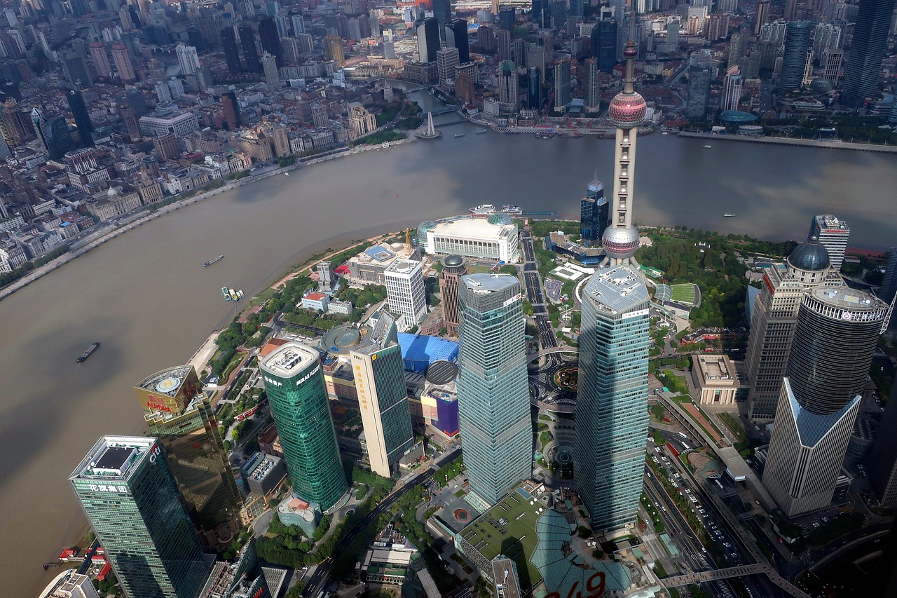 Aerial view of a modern city with tall skyscrapers along a river.