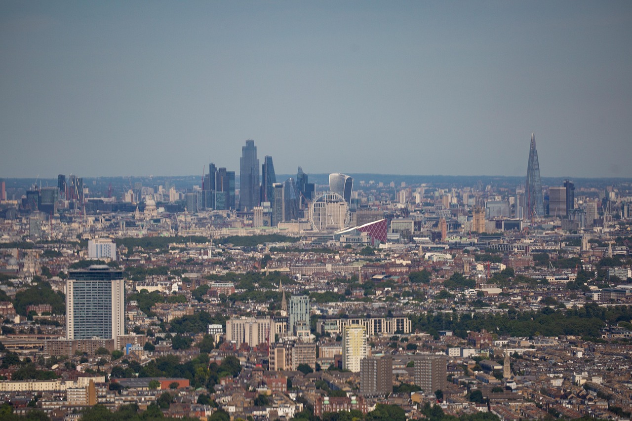 A panoramic view of a city with modern skyscrapers and a mix of residential and commercial buildings.