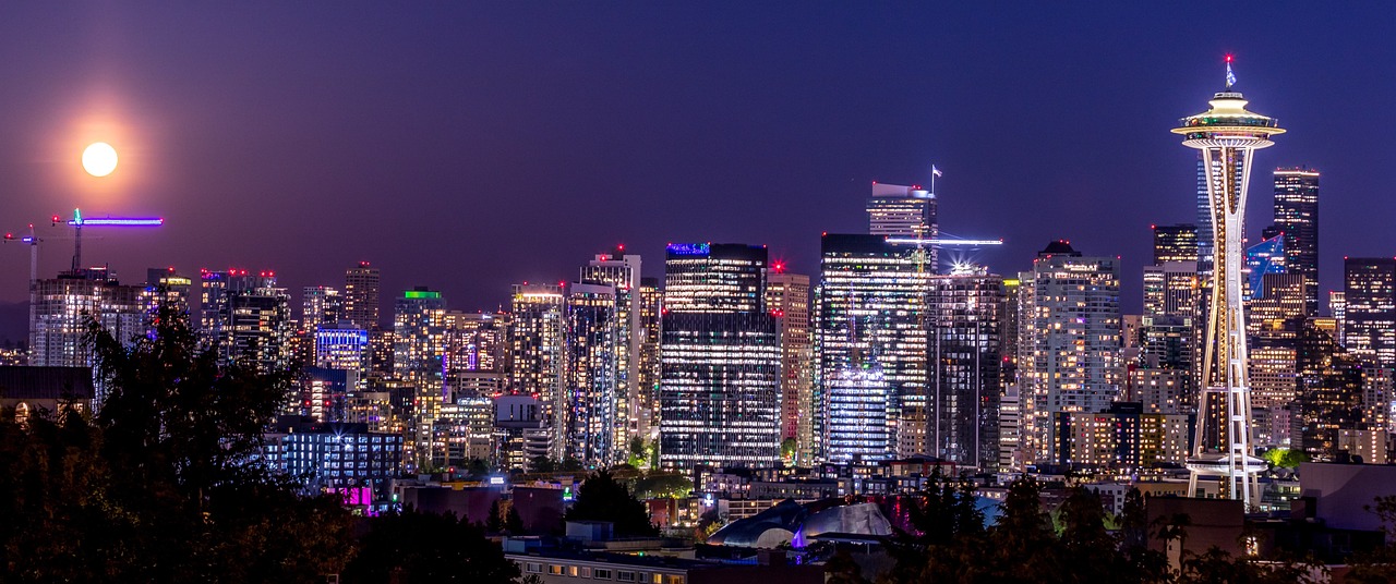 Nighttime cityscape of Seattle with the Space Needle illuminated.
