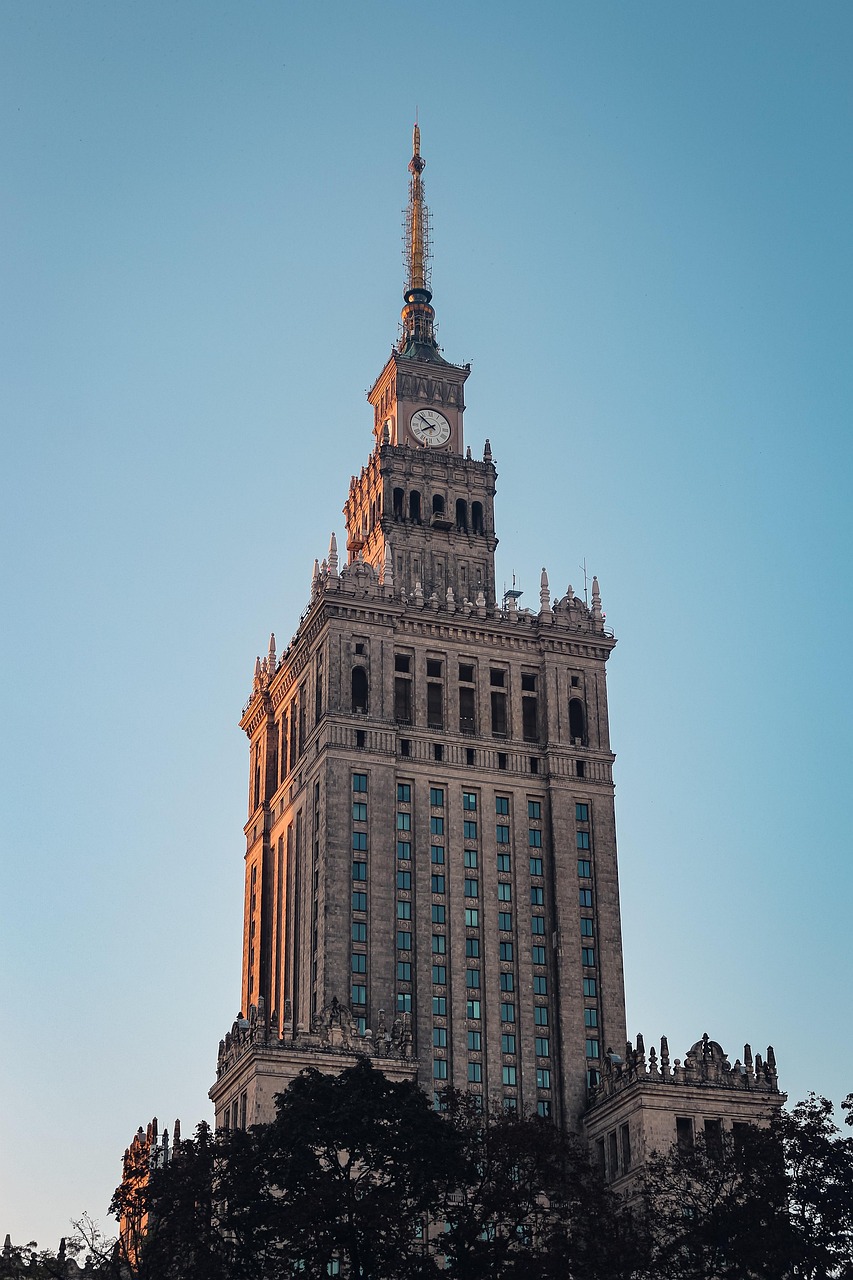 A tall, historic building with a clock tower against a clear sky.