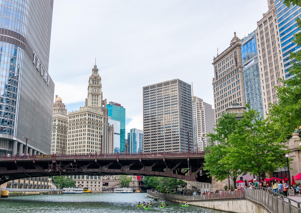 A cityscape view of Chicago with tall buildings, a river, and a bridge.