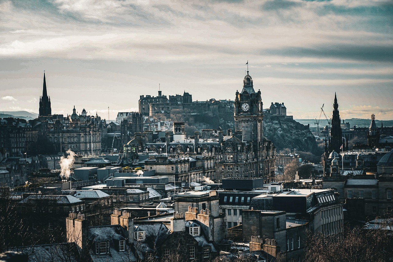A cityscape of Edinburgh with historic buildings and a prominent clock tower.