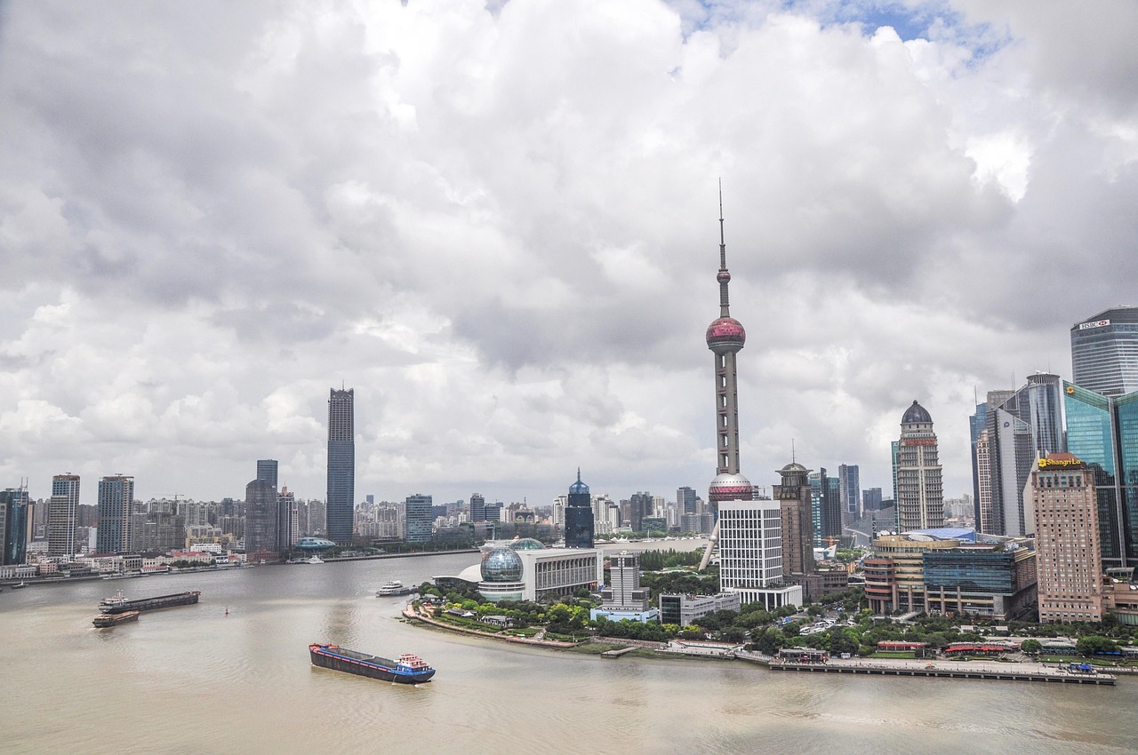 A cityscape of Shanghai with the Oriental Pearl Tower and other skyscrapers along the Huangpu River.