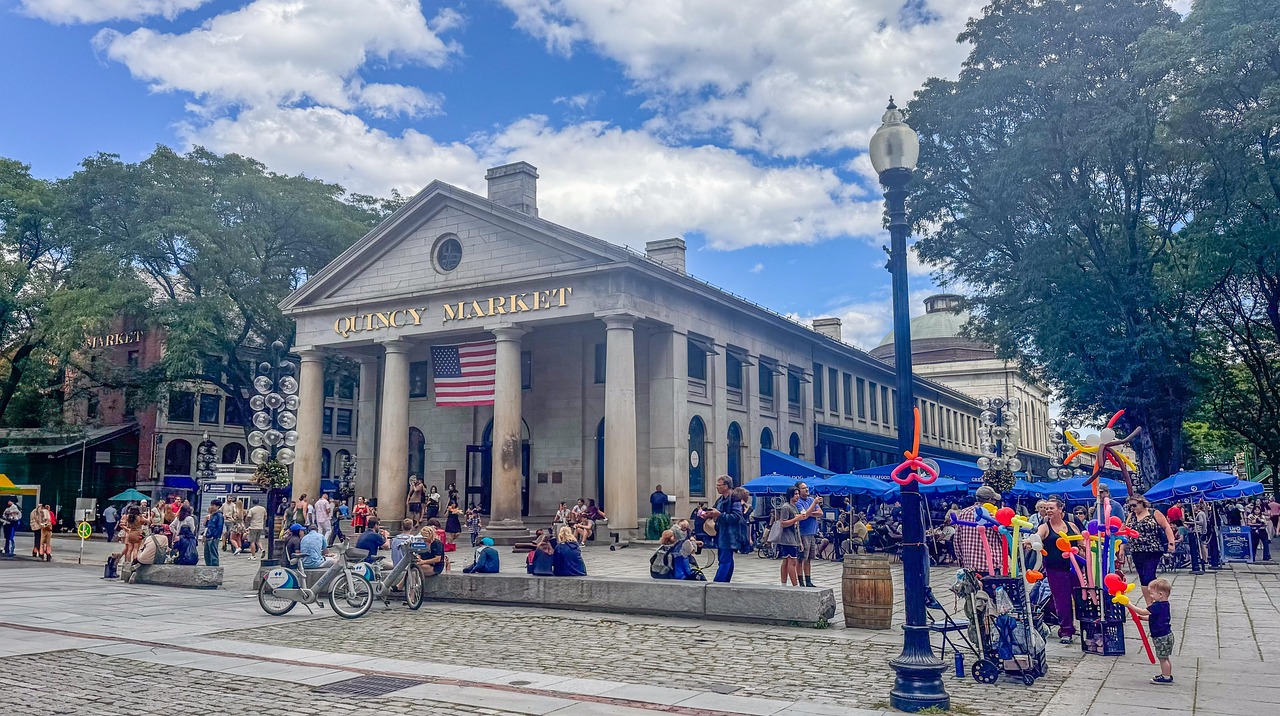 Quincy Market in Boston with people walking around and colorful balloons.